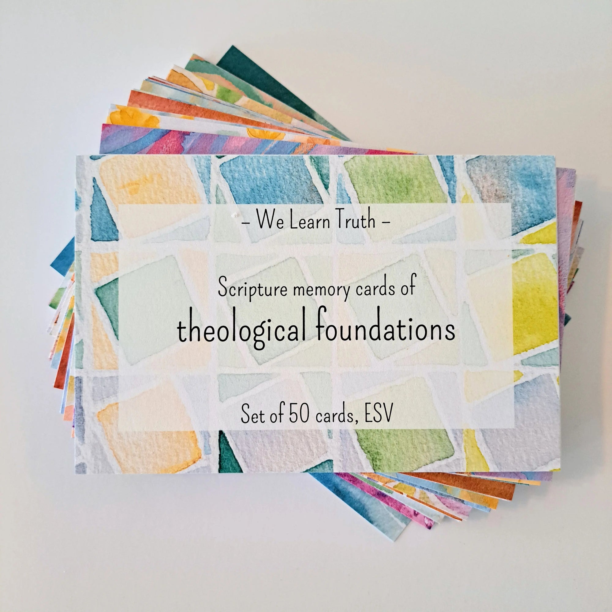 A stack of colorful scripture memory cards with a watercolor design, labeled "We Learn Truth - Scripture memory cards of theological foundations, Set of 50 cards, ESV."