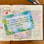 Open Bible with colorful geometric design and text on a wooden surface. Card lists James 1:2-3 -- consider it pure joy...